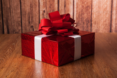 one large red gift box on a wood backgroundの写真素材