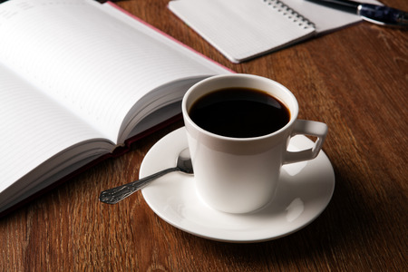 business still life with cup of black coffee on desktopの写真素材