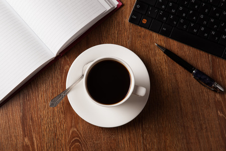 business still life with cup of black coffee on desktopの写真素材