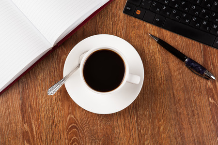 business still life with cup of black coffee on desktopの写真素材