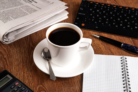 business still life with cup of black coffee on desktopの写真素材