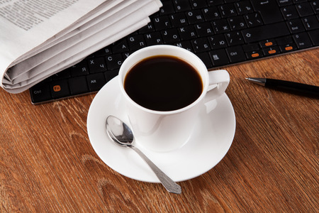 business still life with cup of black coffee on desktopの写真素材