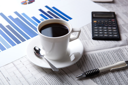 business still life and cup of coffee with newspapersの写真素材