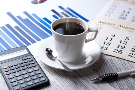 business still life and cup of coffee with newspapersの写真素材