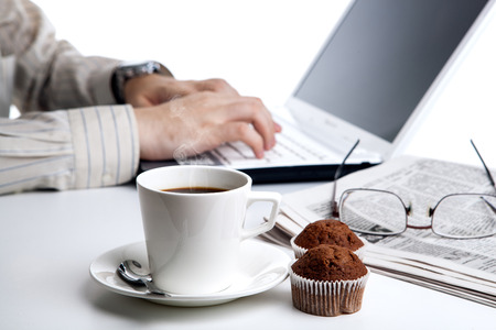 businessman running and a cup of coffee on him desktopの写真素材