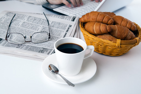 businessman running and a cup of coffee on him desktopの写真素材