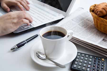 businessman running and a cup of coffee on him desktopの写真素材