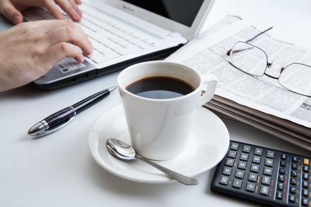 businessman running and a cup of coffee on him desktopの写真素材