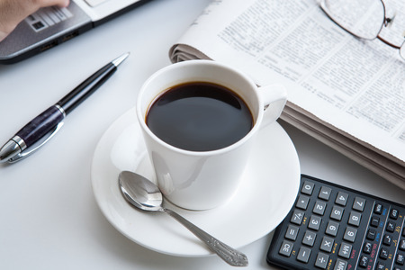 businessman running and a cup of coffee on him desktopの写真素材