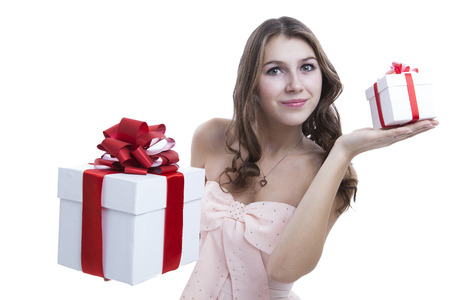 girl in a pink dress holding a gift box on a white backgroundの写真素材