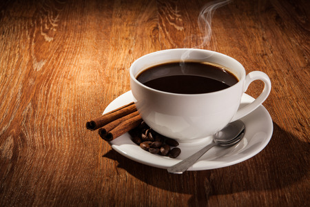 a cup of black coffee and roasted coffee beans close upの写真素材