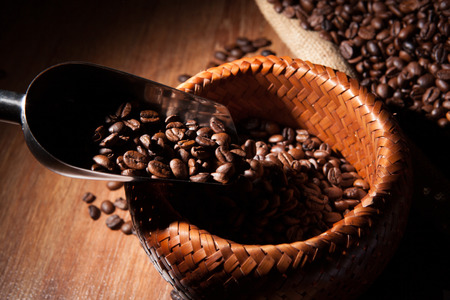 roasted coffee beans in a bamboo basketの写真素材