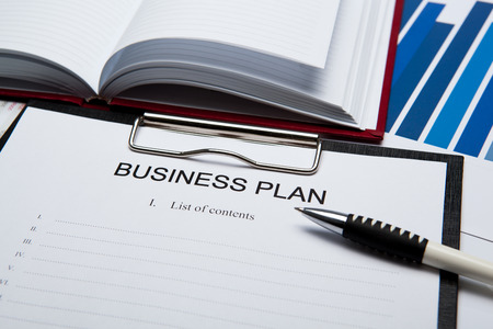 Document with title business plan and office suppliesの写真素材