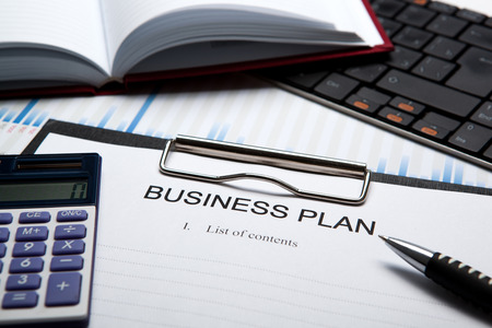 Document with title business plan and office suppliesの写真素材