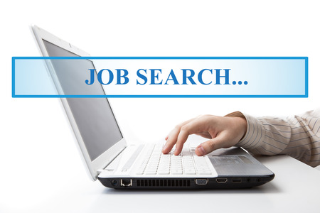 human hand on the keyboard in search of work on a whiteの写真素材