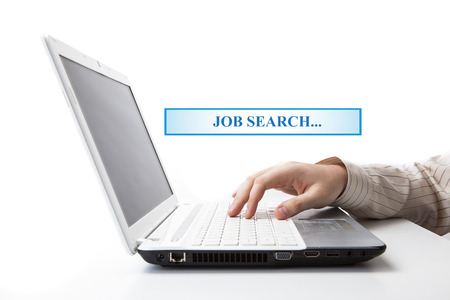 human hand on the keyboard in search of work on a whiteの写真素材