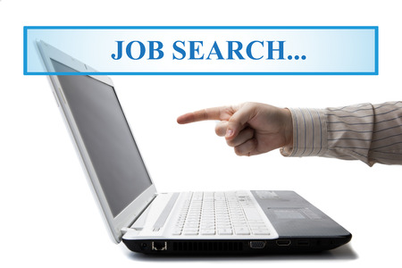 human hand on the keyboard in search of work on a whiteの写真素材