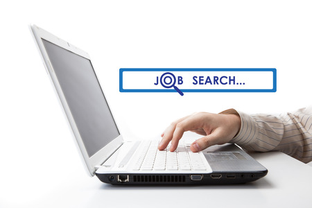 human hand on the keyboard in search of work on a whiteの写真素材