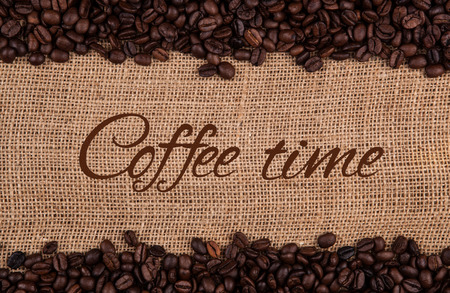 roasted coffee beans on a bag backgroundの写真素材