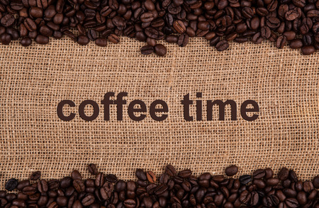 roasted coffee beans on a bag backgroundの写真素材