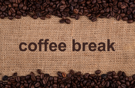 roasted coffee beans on a bag backgroundの写真素材