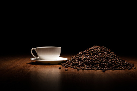 cup of coffee and roasted beans close upの写真素材