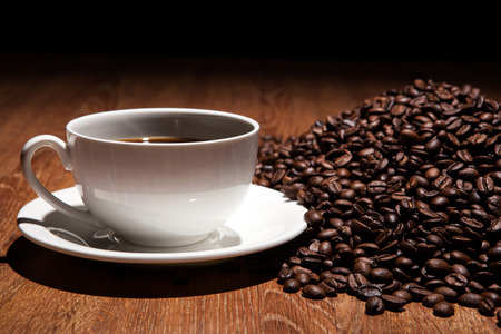 cup of coffee and roasted beans close upの写真素材