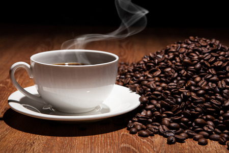 cup of coffee and roasted beans close upの写真素材