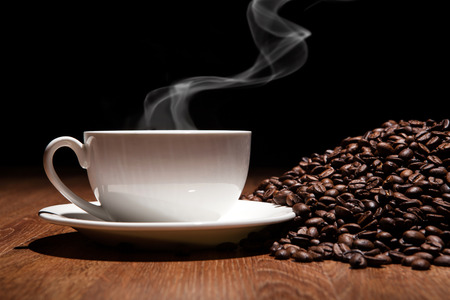 cup of coffee and roasted beans close upの写真素材