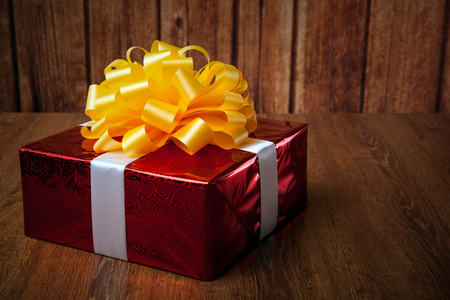 one large red gift box on a wood background