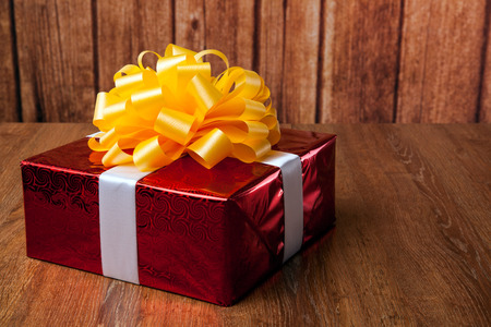 one large red gift box on a wood backgroundの写真素材