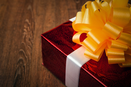 one large red gift box on a wood backgroundの写真素材
