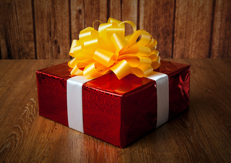 one large red gift box on a wood backgroundの写真素材