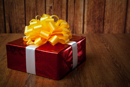 one large red gift box on a wood backgroundの写真素材