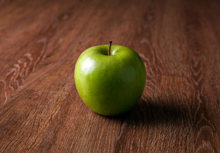 fresh green apple on a wooden table close upの写真素材