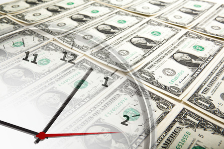 clock on the background of banknotes dollars close upの写真素材