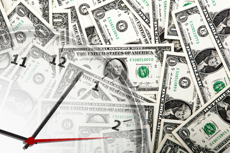 clock on the background of banknotes dollars close upの写真素材