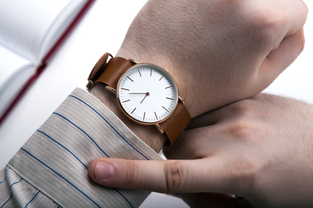 man looking at the time close up isolatedの写真素材