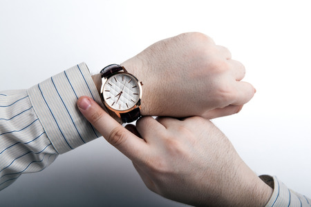 man looking at the time close upの写真素材