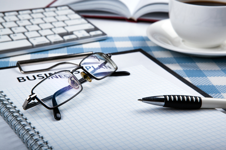 eyeglasses and pen on the workbook close upの写真素材