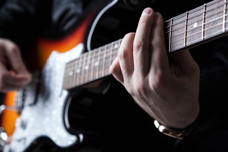 guitarist playing guitar on a black backgroundの写真素材