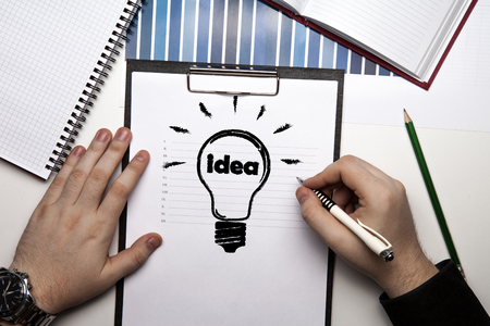 human hands and idea icon on a paper close upの写真素材