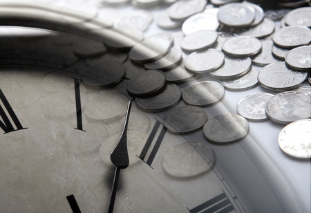 pile of coins with clock face close upの写真素材