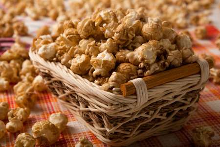 caramel popcorn in a basket on a napkin close upの写真素材