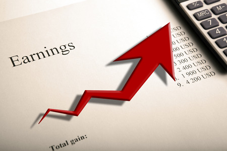 table with earnings with digits, calculator and diagram close upの写真素材
