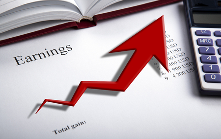 table with earnings with digits, calculator and diagram close upの写真素材