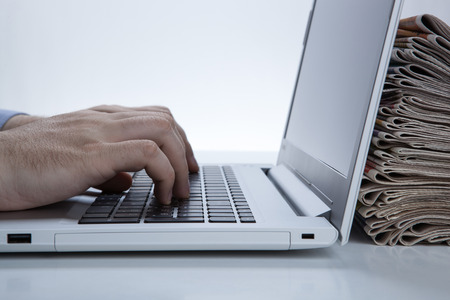 man is working at the computer looking for a jobの写真素材