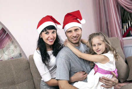 young family of three in Christmas hatsの写真素材