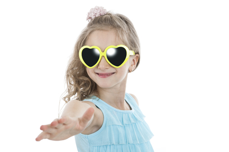 portrait of a little girl in yellow sunglasses on a white backgroundの写真素材