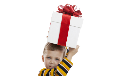 portrait of a little boy with a gift box on a white backgroundの写真素材